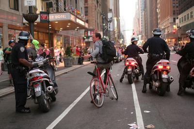 Cyclists being ticketed by 4 policeman.  Photo by Irene  Tejaratchi